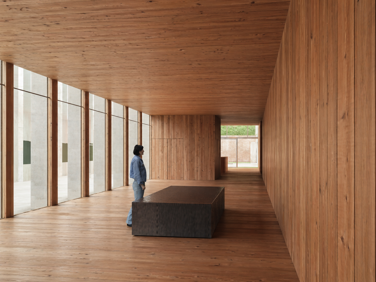 Timber-lined gallery interior with single dark plinth