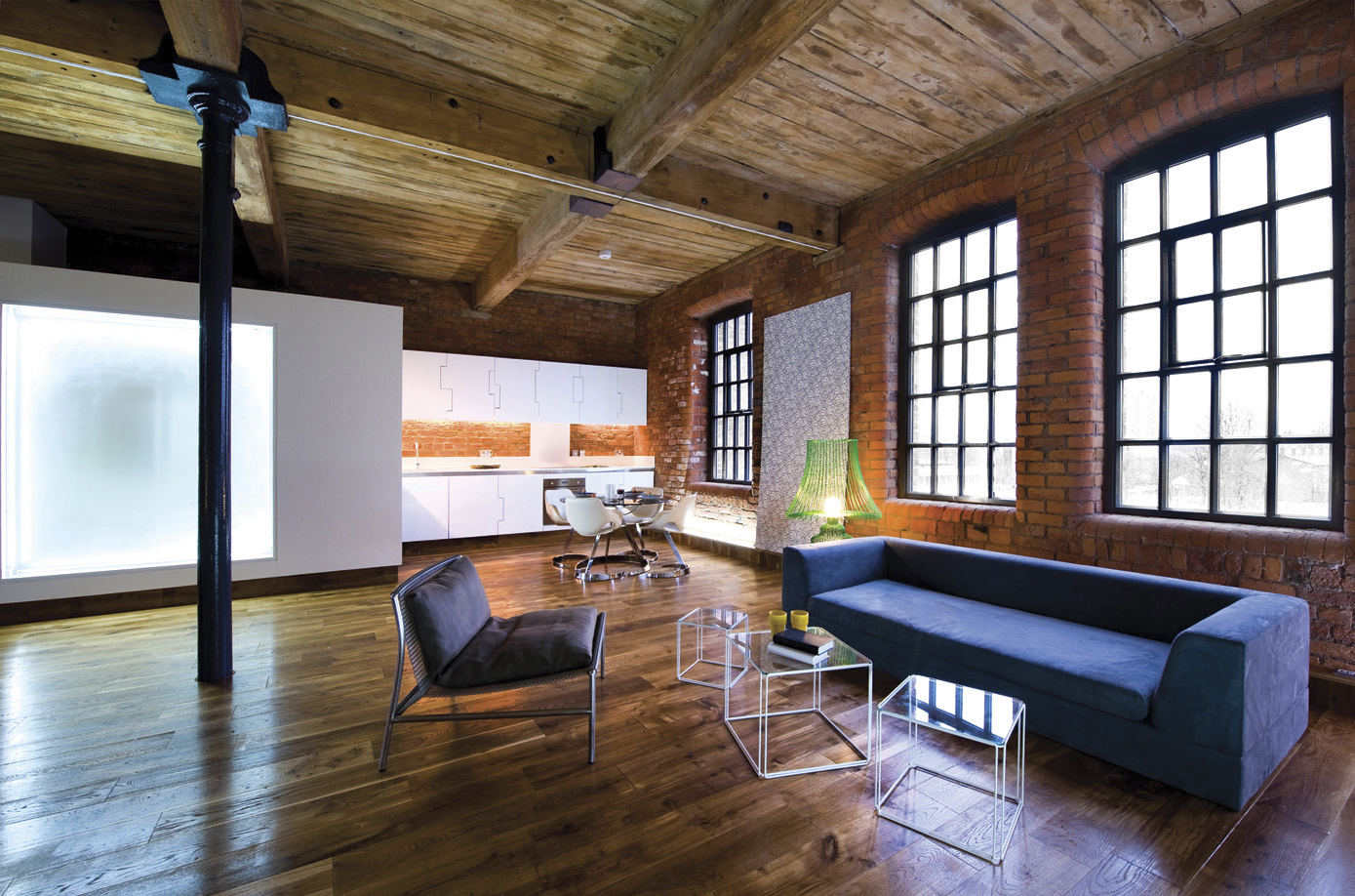 Show apartment — open plan living with bespoke kitchen, translucent glass, brick and timber