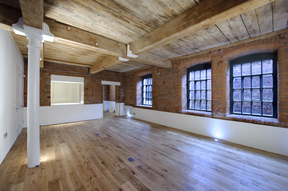 Loft apartment — open living space with bespoke kitchen and translucent glass wall