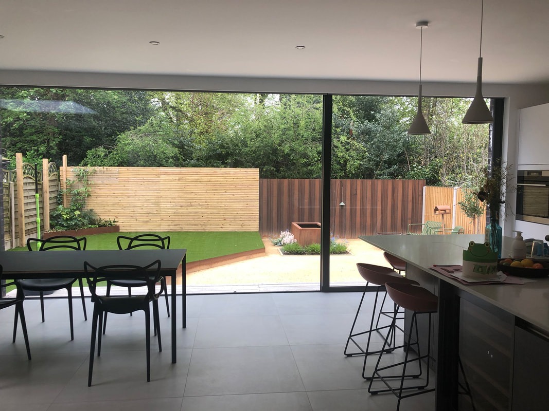 Kitchen–dining space with full-height glazing to the garden