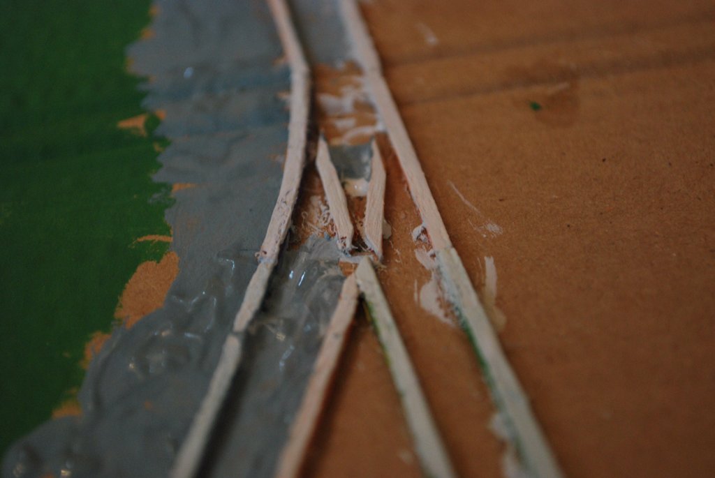 Handmade track detail — matchsticks and glue