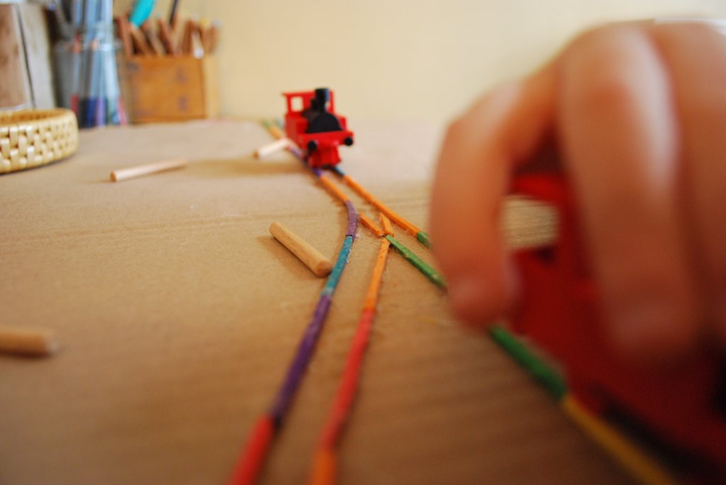 Toy train on handmade coloured pencil tracks
