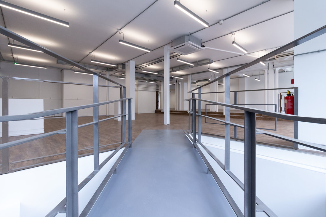 Metal access ramp leading through the open plan office floor