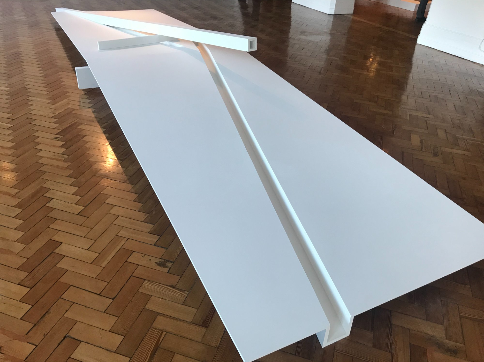 White sculpture on herringbone floor