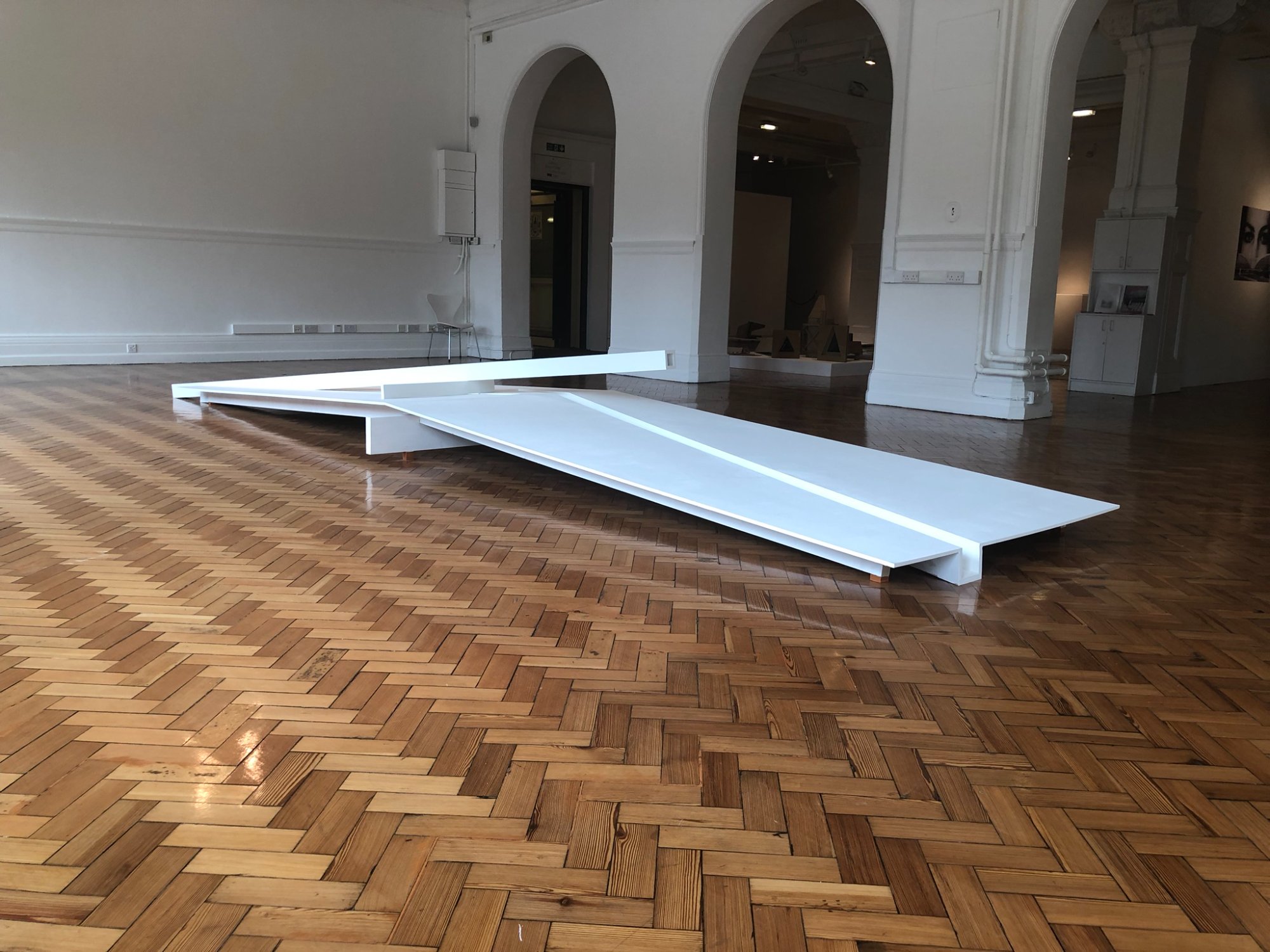 White sculpture with arched doorways