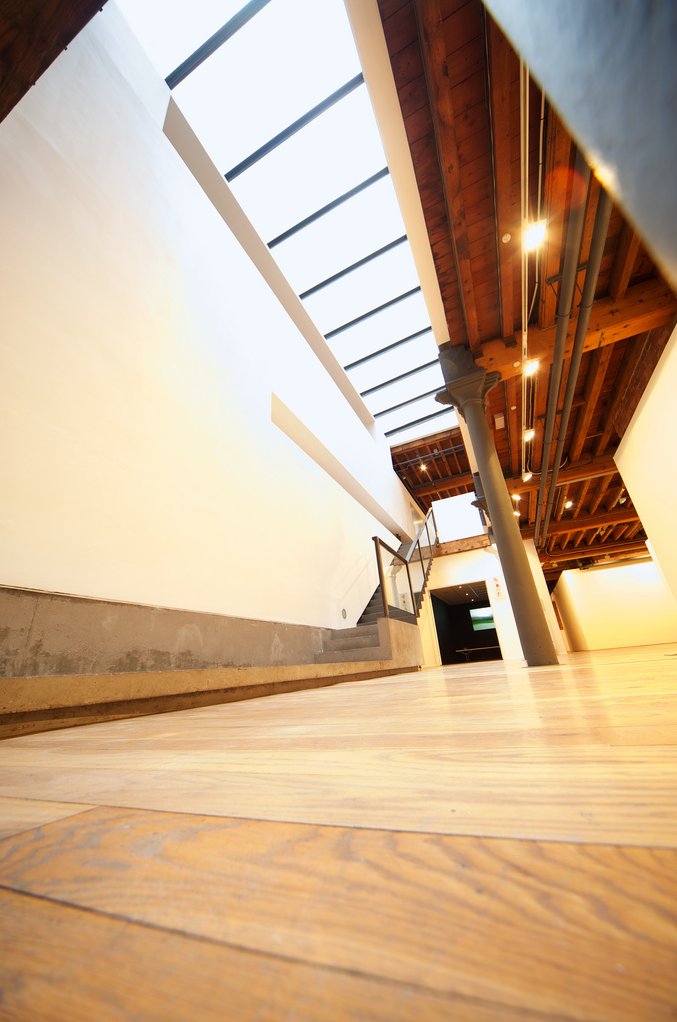 Low angle view — skylight, stairs, cast iron column, timber ceiling