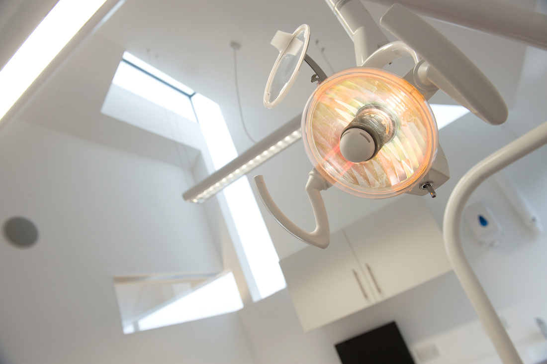 Surgery — dental light, angular skylight above, white walls