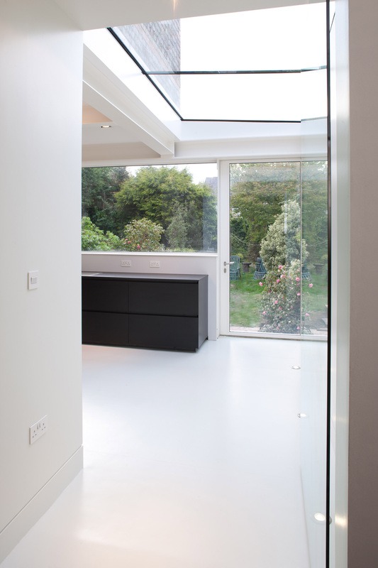 Looking down the corridor into the bright kitchen space
