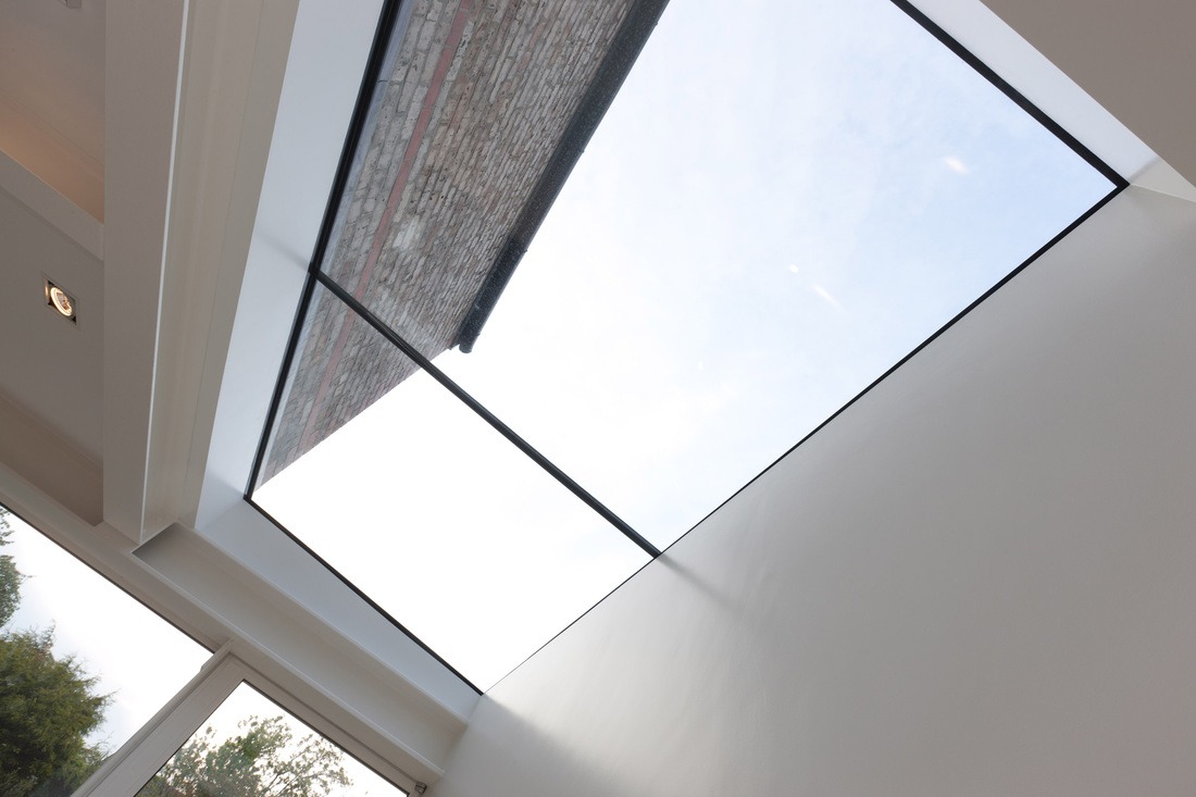 Looking directly up through the structural glass skylight at the Victorian brick wall