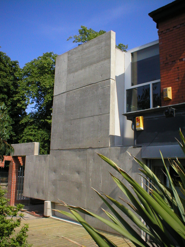 Front view — concrete tower with PALMIRO signage, Edwardian house behind