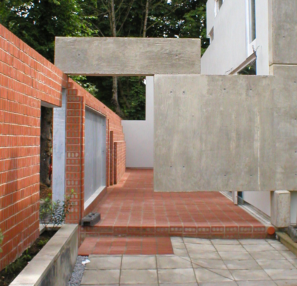 Concrete beam meeting brick wall — material junction detail