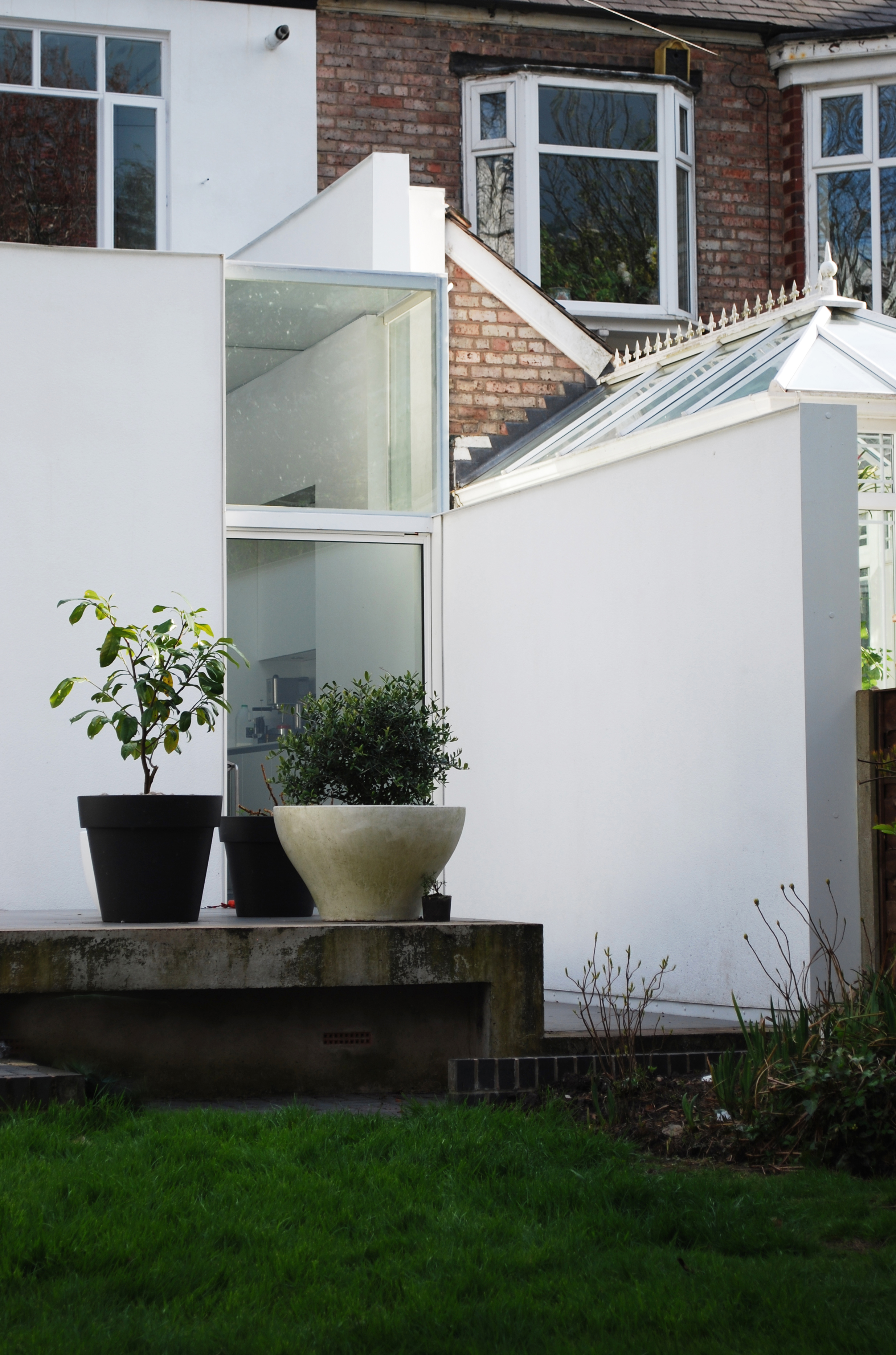 Rear elevation showing a crisp white modern extension against traditional Victorian brickwork