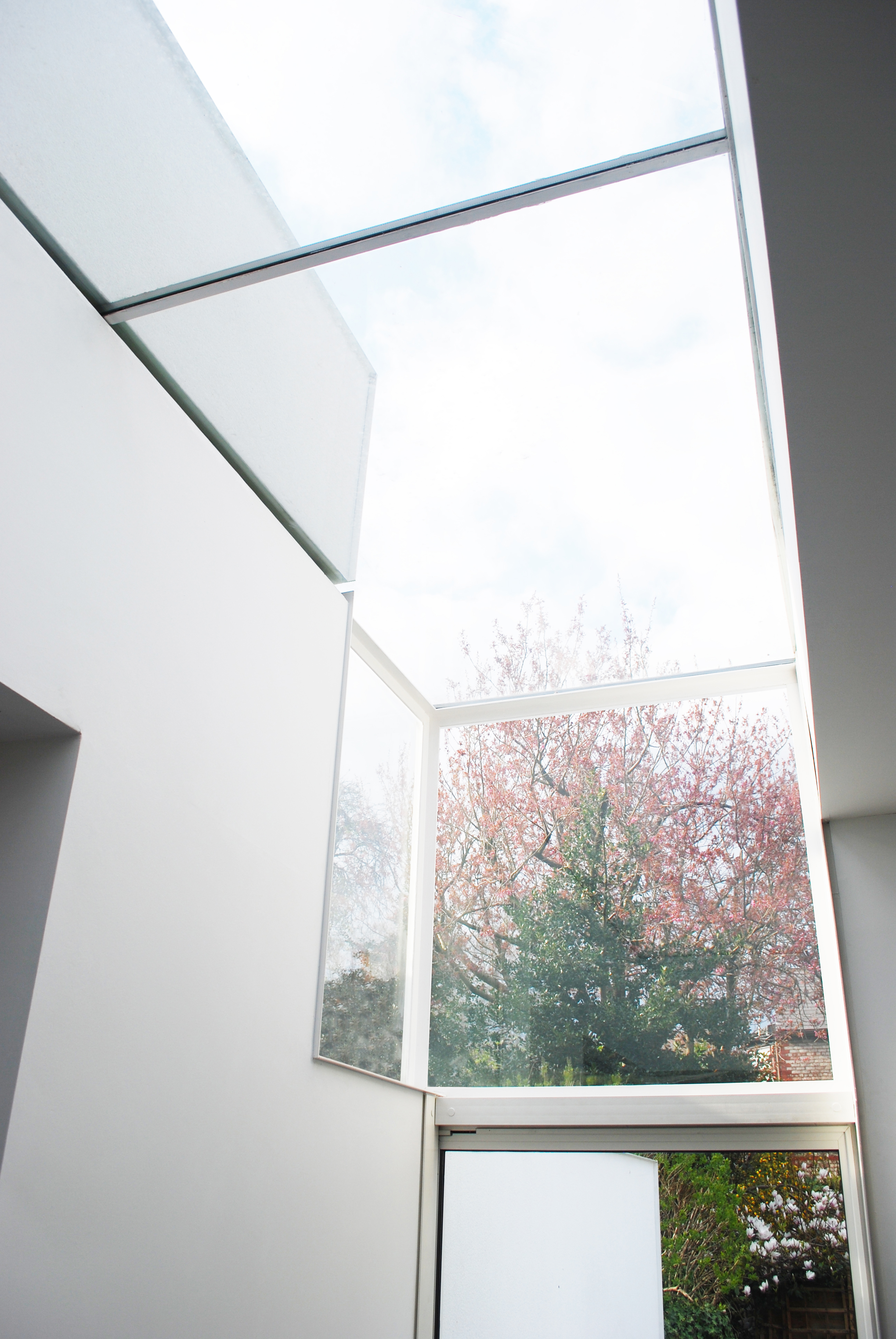 Crisp white kitchen island sitting beneath a bright skylight