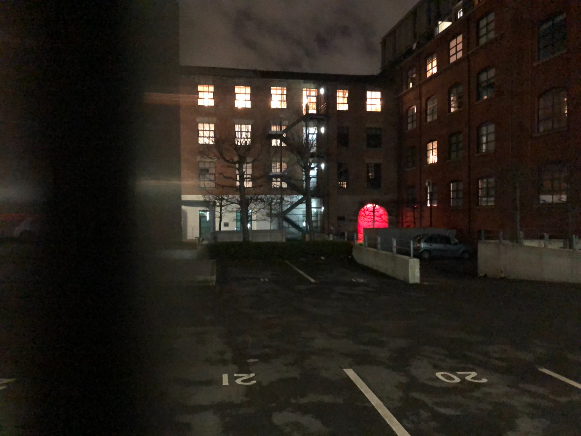 Waulk Mill at night — the red entrance glowing within the mill complex