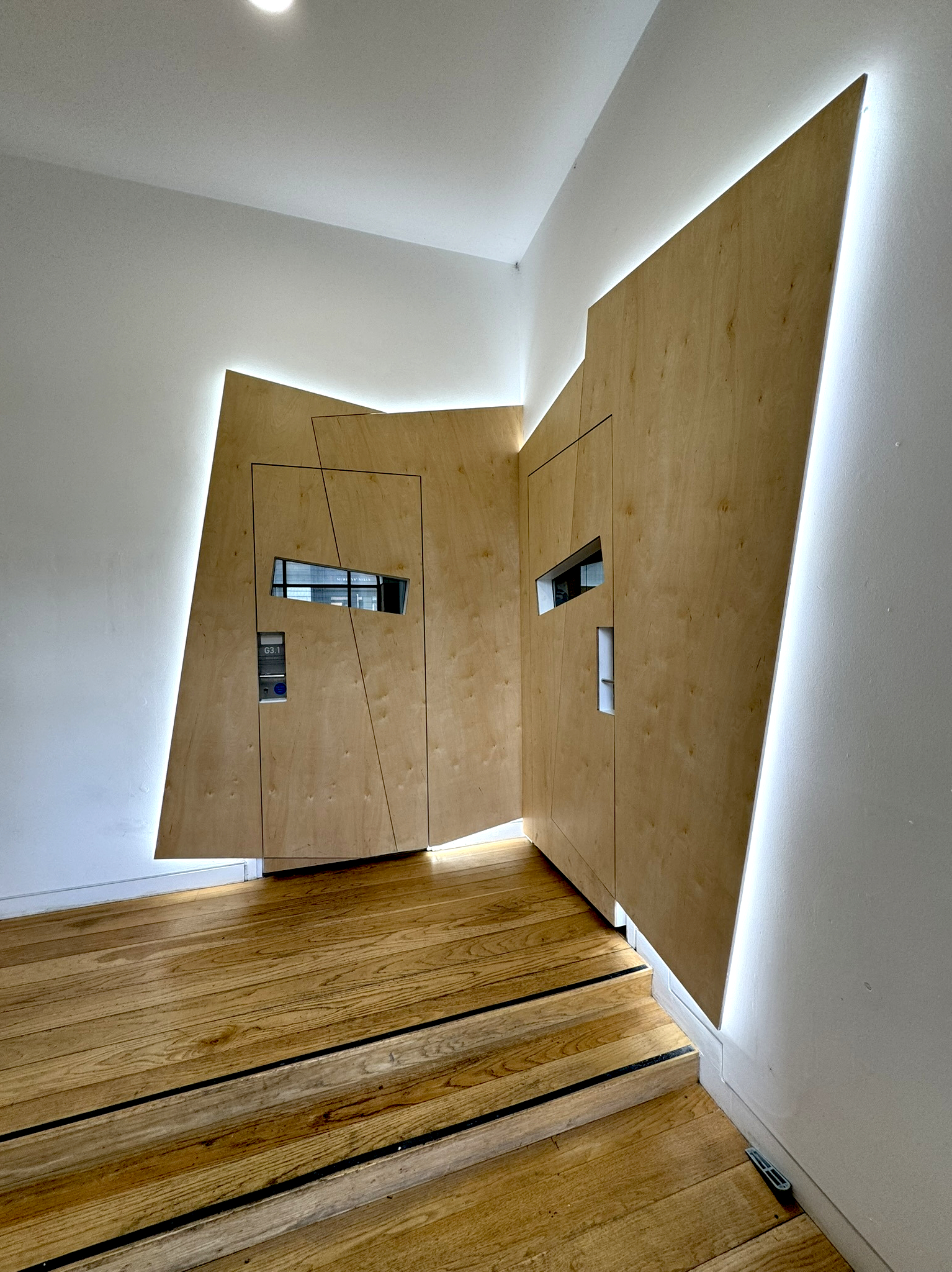 Sculptural birch ply studio doors with integrated backlighting