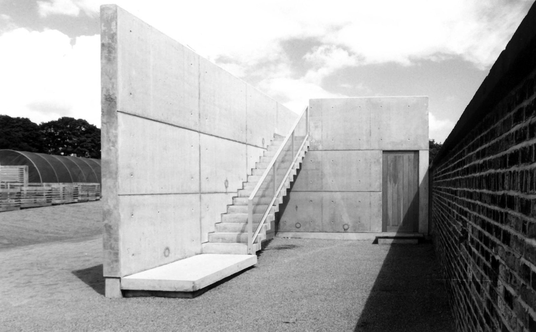 External concrete staircase against brick wall